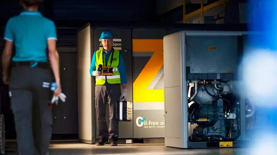 Workers Standing In Front Of Air Compressors — Air Compressors in Toowoomba, QLD
